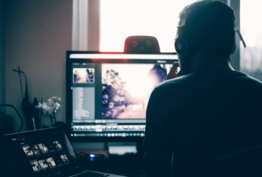 A person sitting in front of a computer screen.