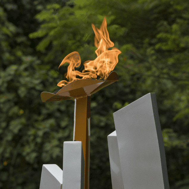 A fire is burning in the middle of a sculpture.
