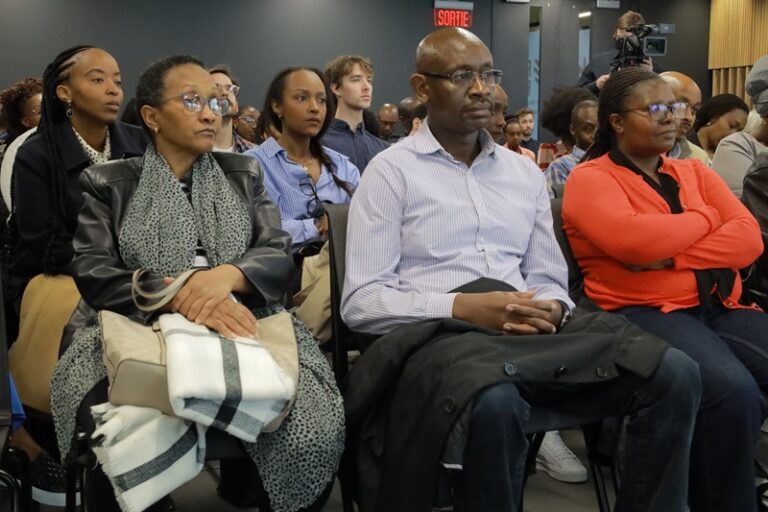 A group of people sitting in chairs at an event.