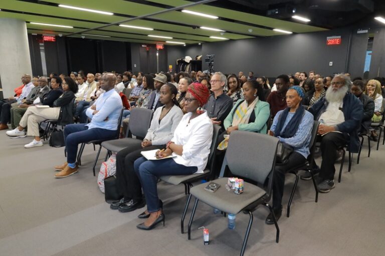 A group of people sitting in chairs at an event.
