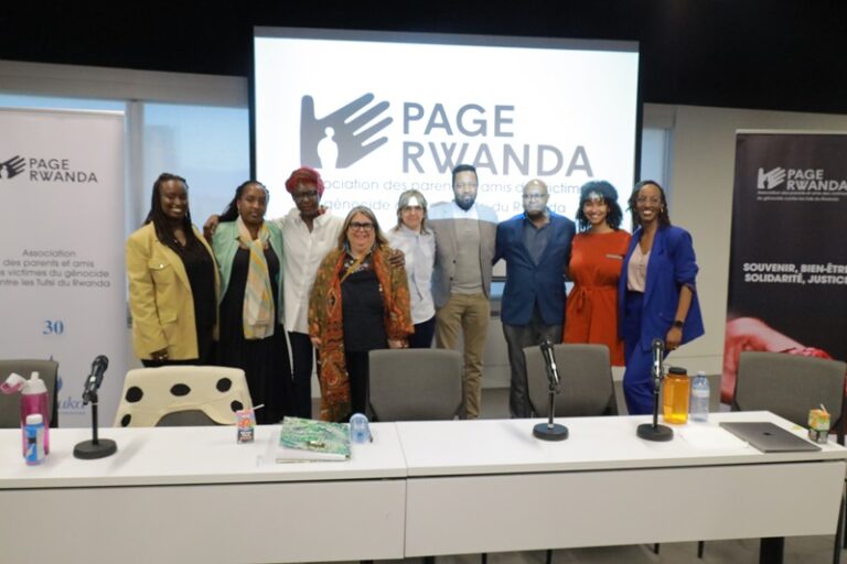 A group of people standing in front of a white board.