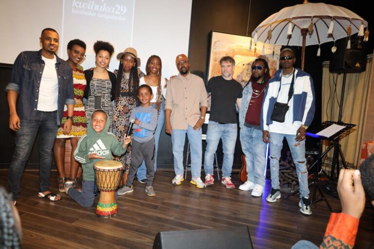 A group of people standing around a drum.