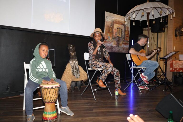 A group of people sitting on chairs in front of an audience.