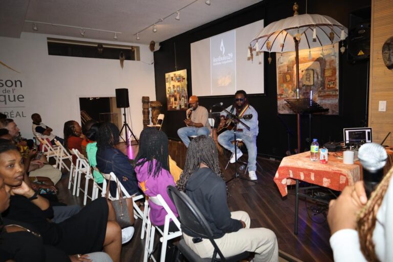 A group of people sitting in chairs and listening to an event.