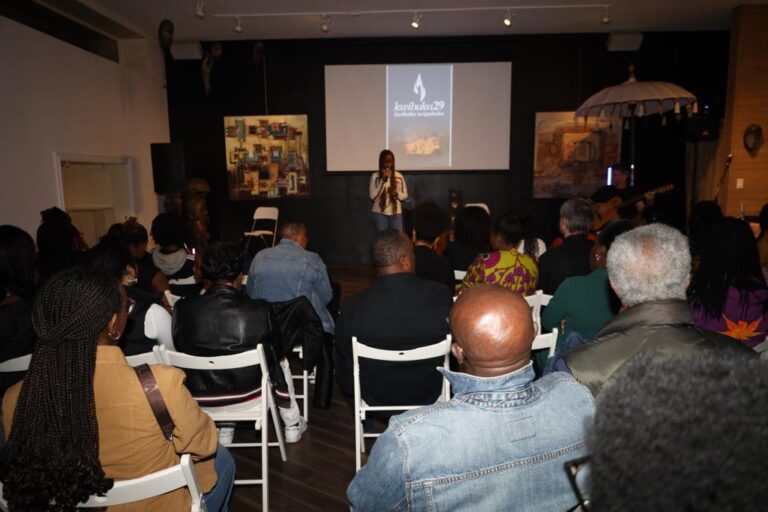 A woman standing in front of an audience.
