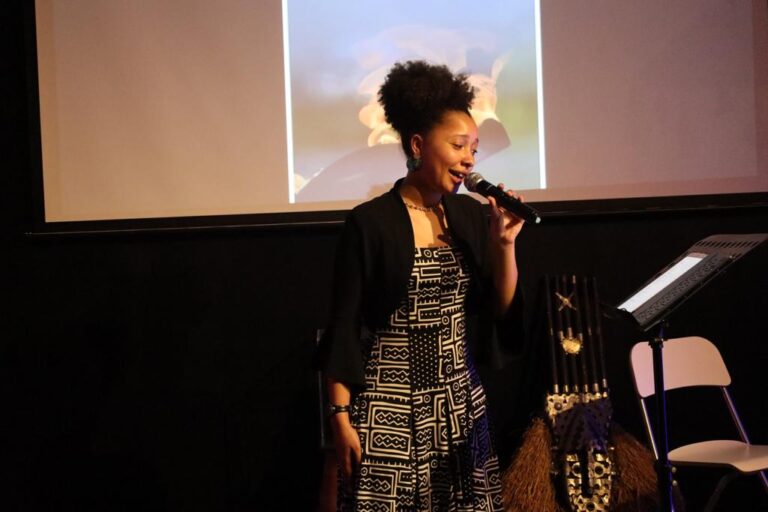 A woman standing in front of a microphone.