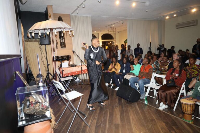 A man standing on the floor in front of an audience.