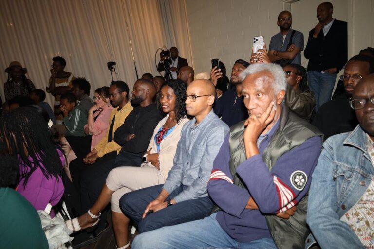 A group of people sitting in front of a camera.