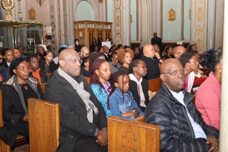 A group of people sitting in pews at an event.
