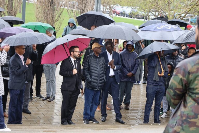 A group of people walking down the street holding umbrellas.