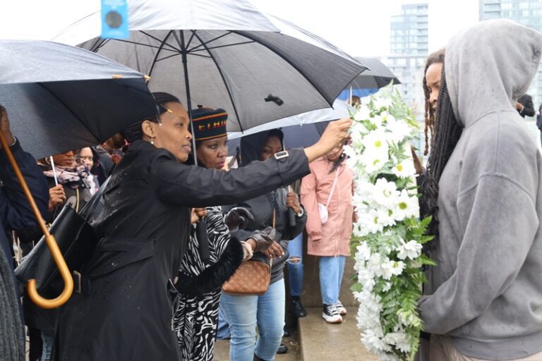 A woman holding an umbrella over her head.