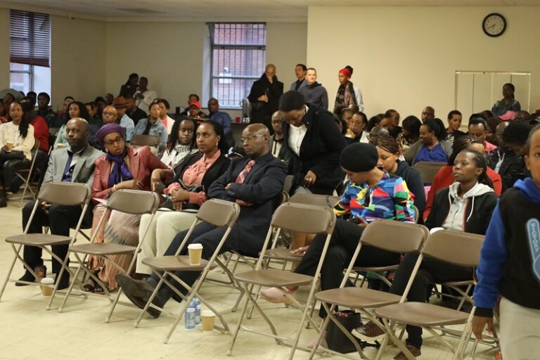 A group of people sitting in chairs at an event.