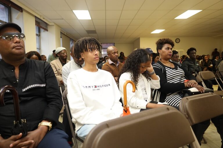 A group of people sitting in chairs at an event.