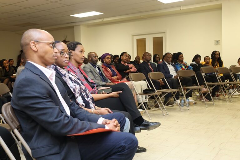 A group of people sitting in rows at an event.