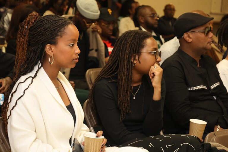 A group of people sitting in front of a crowd.
