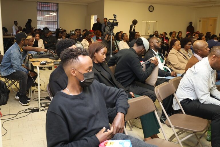 A group of people sitting in chairs at an event.