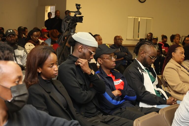 A group of people sitting in front of a camera.