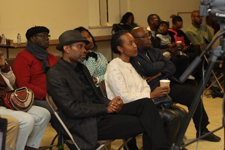 A group of people sitting in chairs at an event.