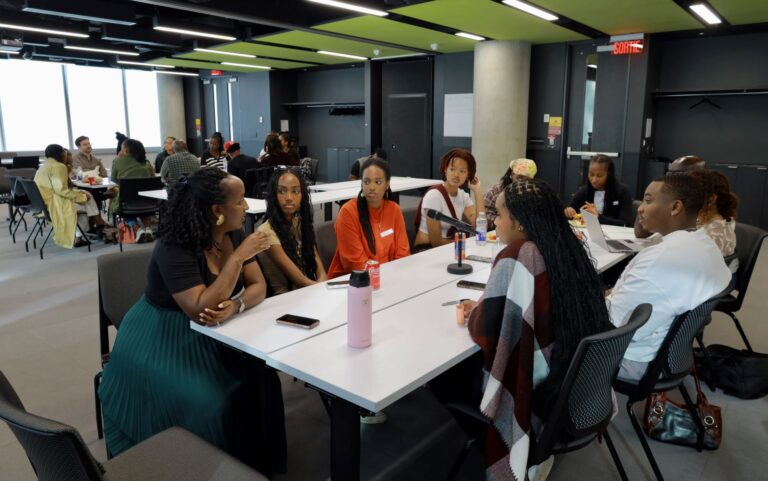 A group of people sitting at a table talking.