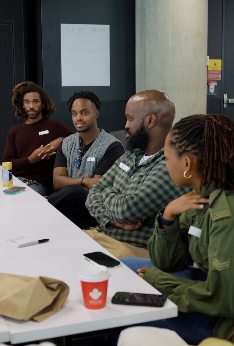 A group of people sitting at a table talking.