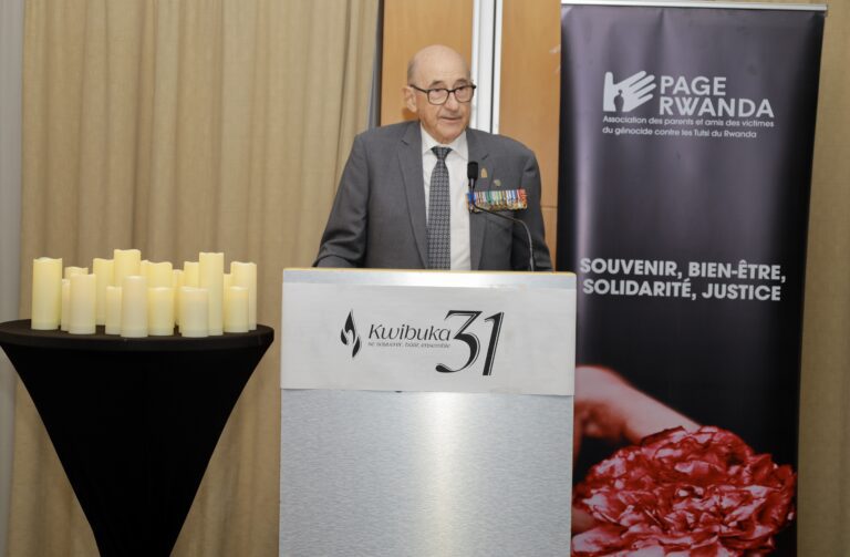 Man speaking at a memorial event podium.