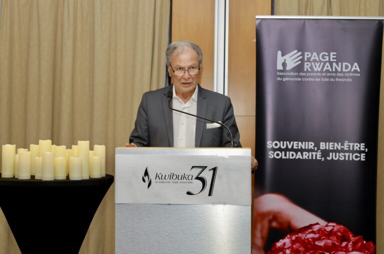 Man speaking at a memorial event podium.