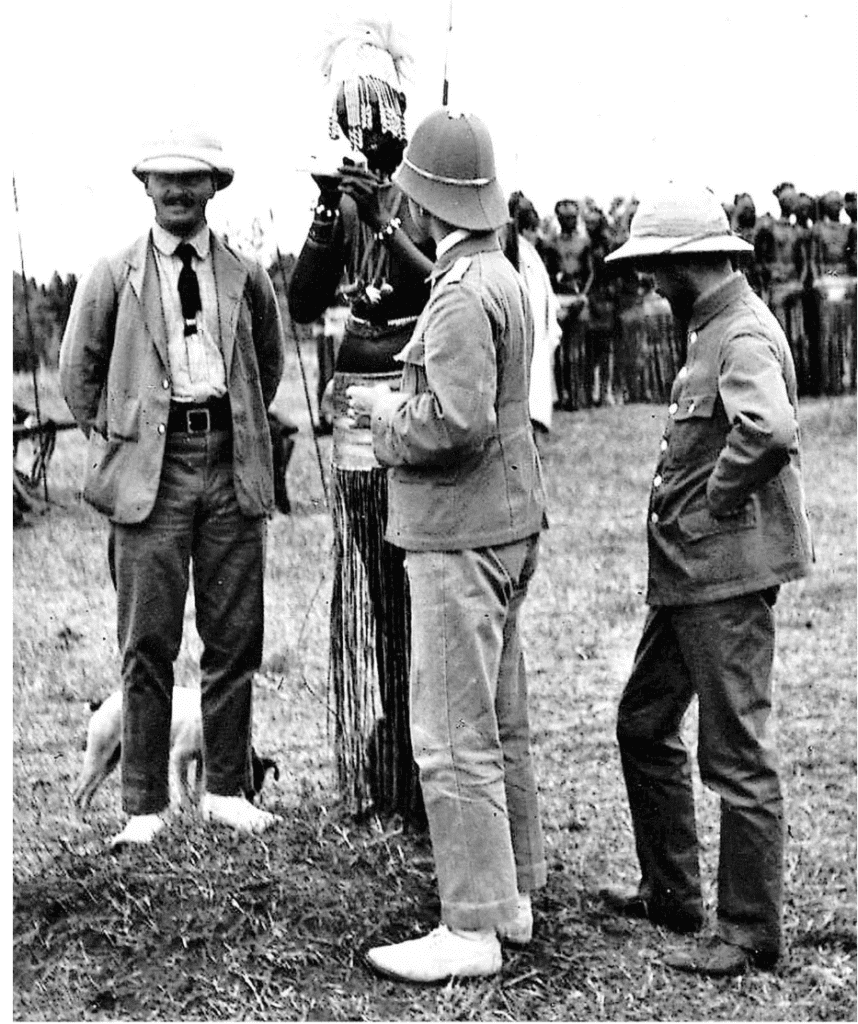 Men in pith helmets with Maasai person.